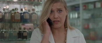 Movie still from “Bullhead” (2011), directed by Michaël R. Roskam – A woman talking on a cell phone while wearing a white shirt; Close Up shot, Low angle