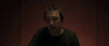 Movie still from “Bullhead” (2011), directed by Michaël R. Roskam – A person wearing a black t - shirt; Close Up shot, Low angle