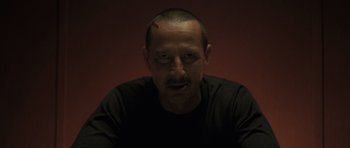 Movie still from “Bullhead” (2011), directed by Michaël R. Roskam – A person wearing a black t - shirt; Close Up shot, Low angle