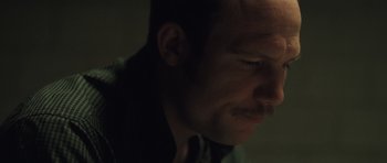 Movie still from “Bullhead” (2011), directed by Michaël R. Roskam – A person with a mustache; Close Up shot, Low angle