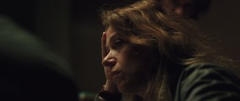Movie still from “Bullhead” (2011), directed by Michaël R. Roskam – A person with her hand to her face; Close Up shot, Low angle