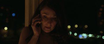 Movie still from “Bullhead” (2011), directed by Michaël R. Roskam – A woman talking on a cell phone in the dark; Close Up shot, Low angle