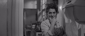 Movie still from “Bunny Lake Is Missing” (1965), directed by Otto Preminger – An older woman in an apron in a kitchen; Close Up shot, Low angle
