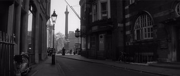 Movie still from “Bunny Lake Is Missing” (1965), directed by Otto Preminger – An old photo of a street corner with a lamp post in the background; Extreme Wide shot, Low angle