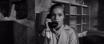 Movie still from “Bunny Lake Is Missing” (1965), directed by Otto Preminger – A woman is talking on a phone in a room; Close Up shot, Low angle