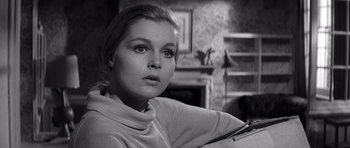 Movie still from “Bunny Lake Is Missing” (1965), directed by Otto Preminger – A black - and - white photo of a woman in a room; Close Up shot, Low angle