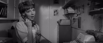 Movie still from “Bunny Lake Is Missing” (1965), directed by Otto Preminger – A woman holding a phone up to her ear; Close Up shot, High angle