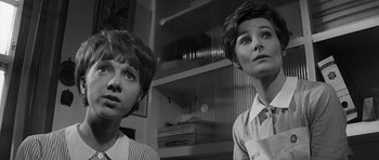 Movie still from “Bunny Lake Is Missing” (1965), directed by Otto Preminger – Two women looking at the camera in a room; Close Up shot, Low angle