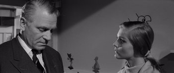 Movie still from “Bunny Lake Is Missing” (1965), directed by Otto Preminger – A man and a woman standing next to each other in a room; Close Up shot, Over the shoulder angle