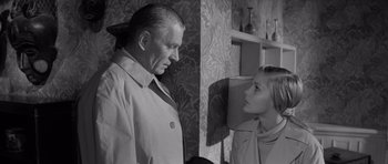 Movie still from “Bunny Lake Is Missing” (1965), directed by Otto Preminger – An older man and a young woman in a room; Medium shot, Low angle