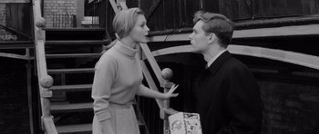 Movie still from “Bunny Lake Is Missing” (1965), directed by Otto Preminger – A man and a woman talking to each other outside; Medium shot, Low angle