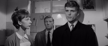 Movie still from “Bunny Lake Is Missing” (1965), directed by Otto Preminger – A black and white photo of two men in suits and ties; Close Up shot, Low angle