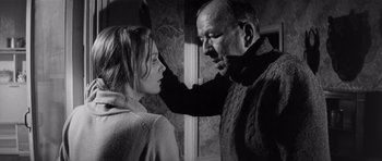 Movie still from “Bunny Lake Is Missing” (1965), directed by Otto Preminger – An older man touching a young woman's face; Medium shot, Low angle