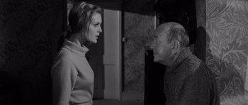 Movie still from “Bunny Lake Is Missing” (1965), directed by Otto Preminger – An older man and a younger woman talking to each other; Medium shot, Over the shoulder angle