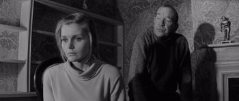 Movie still from “Bunny Lake Is Missing” (1965), directed by Otto Preminger – A man and a woman are standing next to each other; Medium shot, Over the shoulder angle