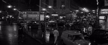 Movie still from “Bunny Lake Is Missing” (1965), directed by Otto Preminger – A man walking on a busy city street at night; Extreme Wide shot, High angle