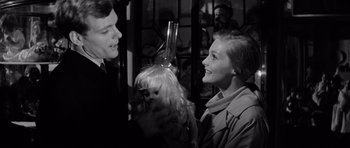 Movie still from “Bunny Lake Is Missing” (1965), directed by Otto Preminger – A man and a woman talking to a doll; Close Up shot, Over the shoulder angle