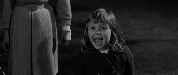 Movie still from “Bunny Lake Is Missing” (1965), directed by Otto Preminger – A little girl in a black coat and white shirt; Close Up shot, High angle
