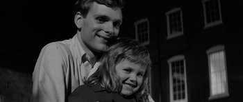 Movie still from “Bunny Lake Is Missing” (1965), directed by Otto Preminger – A man and a little girl smiling for the camera; Close Up shot, High angle