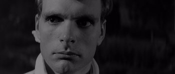 Movie still from “Bunny Lake Is Missing” (1965), directed by Otto Preminger – A man's face in black - and - white; Close Up shot, High angle