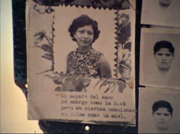 Movie still from “Burden of Dreams” (1982), directed by Les Blank – An old photo of a woman in a floral dress; Extreme Close Up shot, High angle
