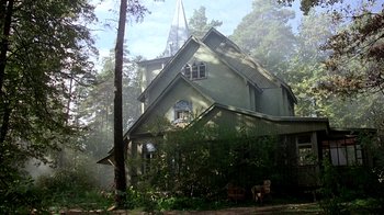 Movie still from “Burnt by the Sun” (1994), directed by Nikita Mikhalkov – A large green church with trees in front of it; Extreme Wide shot, Low angle