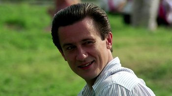 Movie still from “Burnt by the Sun” (1994), directed by Nikita Mikhalkov – A person smiling for the camera; Close Up shot, Low angle