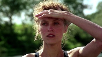 Movie still from “Burnt by the Sun” (1994), directed by Nikita Mikhalkov – A person holding her hand up to her forehead; Close Up shot, Low angle