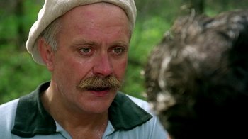 Movie still from “Burnt by the Sun” (1994), directed by Nikita Mikhalkov – An older man with a mustache and a hat; Close Up shot, Over the shoulder angle