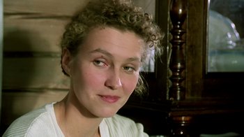 Movie still from “Burnt by the Sun” (1994), directed by Nikita Mikhalkov – A person with curly hair; Close Up shot, Over the shoulder angle