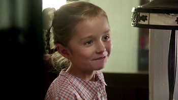Movie still from “Burnt by the Sun” (1994), directed by Nikita Mikhalkov – A little girl is smiling for the camera; Close Up shot, Over the shoulder angle