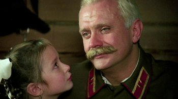 Movie still from “Burnt by the Sun” (1994), directed by Nikita Mikhalkov – An older man and a young girl look at each other; Close Up shot, Low angle