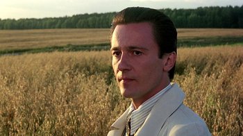 Movie still from “Burnt by the Sun” (1994), directed by Nikita Mikhalkov – A person in a field; Close Up shot, Low angle