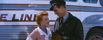 Movie still from “Bus Stop” (1956), directed by Joshua Logan – An older woman standing next to an older man in front of an airplane; Medium shot, Low angle