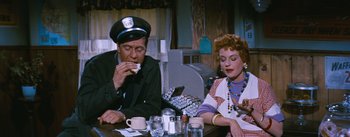 Movie still from “Bus Stop” (1956), directed by Joshua Logan – A man and a woman sitting at a table; Medium shot, Over the shoulder angle