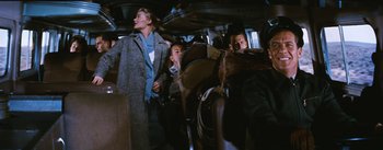 Movie still from “Bus Stop” (1956), directed by Joshua Logan – A group of people riding on a train; Medium shot, Low angle