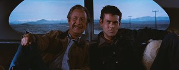 Movie still from “Bus Stop” (1956), directed by Joshua Logan – Two men sitting next to each other on a bus; Medium shot, Low angle