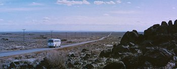 Movie still from “Bus Stop” (1956), directed by Joshua Logan – A van driving down a dirt road in the middle of the desert; Extreme Wide shot, Low angle