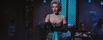 Movie still from “Bus Stop” (1956), directed by Joshua Logan – A woman wearing a green dress and black gloves; Medium shot, Over the shoulder angle