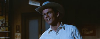 Movie still from “Bus Stop” (1956), directed by Joshua Logan – A man wearing a white shirt and a cowboy hat; Close Up shot, Low angle