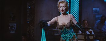 Movie still from “Bus Stop” (1956), directed by Joshua Logan – A woman in a blue dress holding onto a blue cloth; Medium shot, Over the shoulder angle