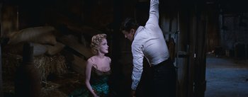 Movie still from “Bus Stop” (1956), directed by Joshua Logan – A man and a woman are standing next to each other; Medium shot, Low angle