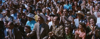 Movie still from “Bus Stop” (1956), directed by Joshua Logan – A group of people standing in front of each other; Wide shot, High angle