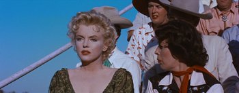 Movie still from “Bus Stop” (1956), directed by Joshua Logan – A woman in a green dress and a man in a cowboy hat; Close Up shot, Over the shoulder angle