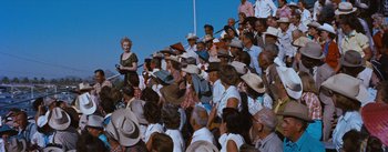 Movie still from “Bus Stop” (1956), directed by Joshua Logan – A crowd of people wearing cowboy hats and hats; Wide shot, High angle