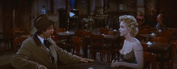 Movie still from “Bus Stop” (1956), directed by Joshua Logan – A man and a woman sitting at a table in a restaurant; Medium shot, Over the shoulder angle