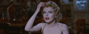 Movie still from “Bus Stop” (1956), directed by Joshua Logan – A person holding their hand up to her head; Close Up shot, Over the shoulder angle