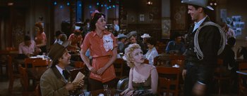 Movie still from “Bus Stop” (1956), directed by Joshua Logan – Two women are sitting at a table in a restaurant; Medium shot, Over the shoulder angle