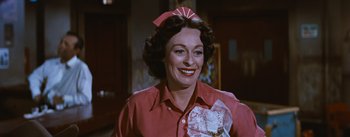 Movie still from “Bus Stop” (1956), directed by Joshua Logan – An older woman wearing a red shirt holding a piece of paper; Close Up shot, Low angle