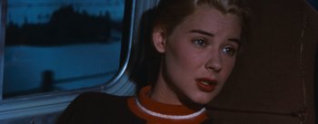 Movie still from “Bus Stop” (1956), directed by Joshua Logan – A person wearing a red and white sweater; Close Up shot, Over the shoulder angle